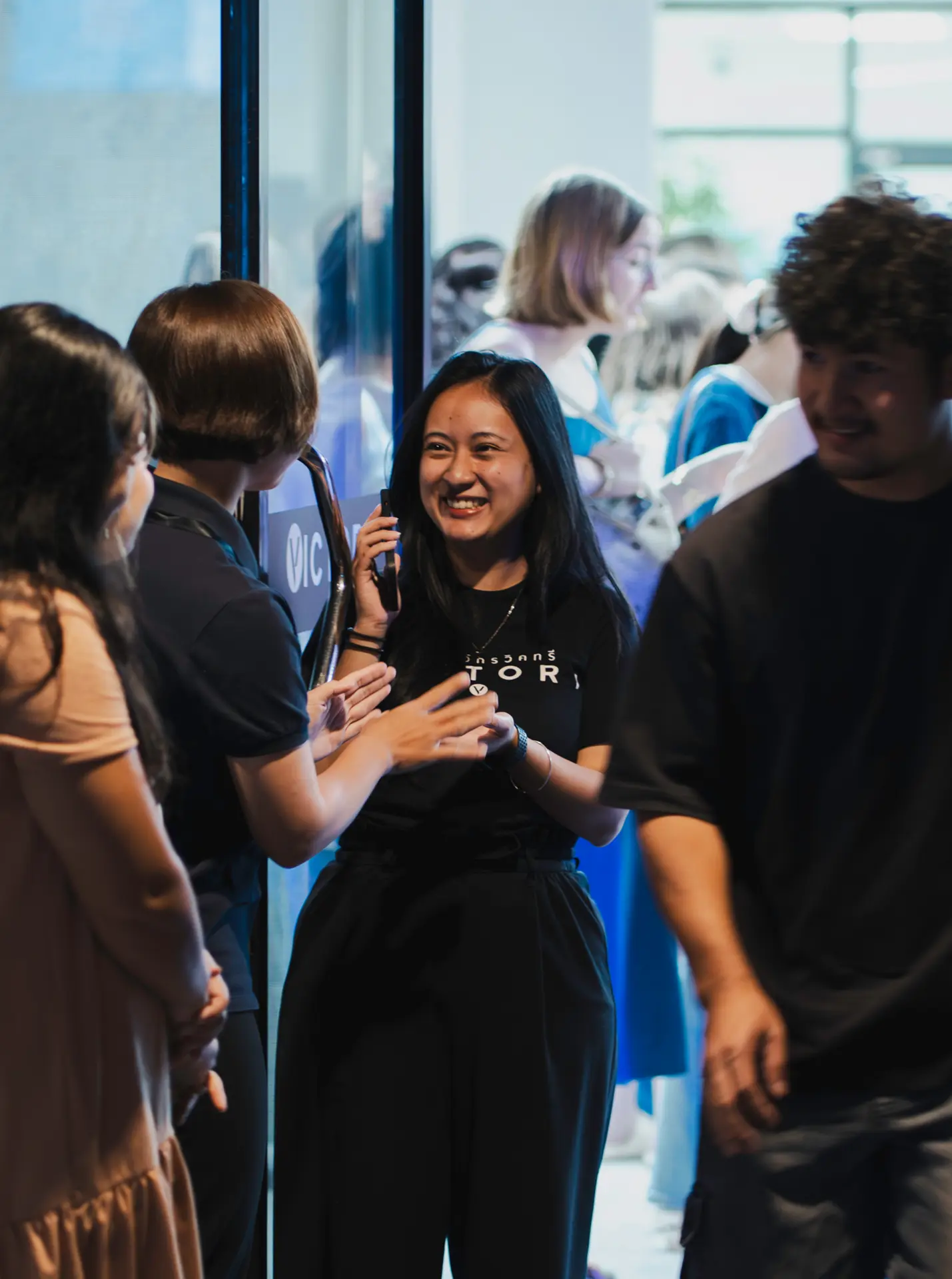 A smiling woman chats with church members after a gathering