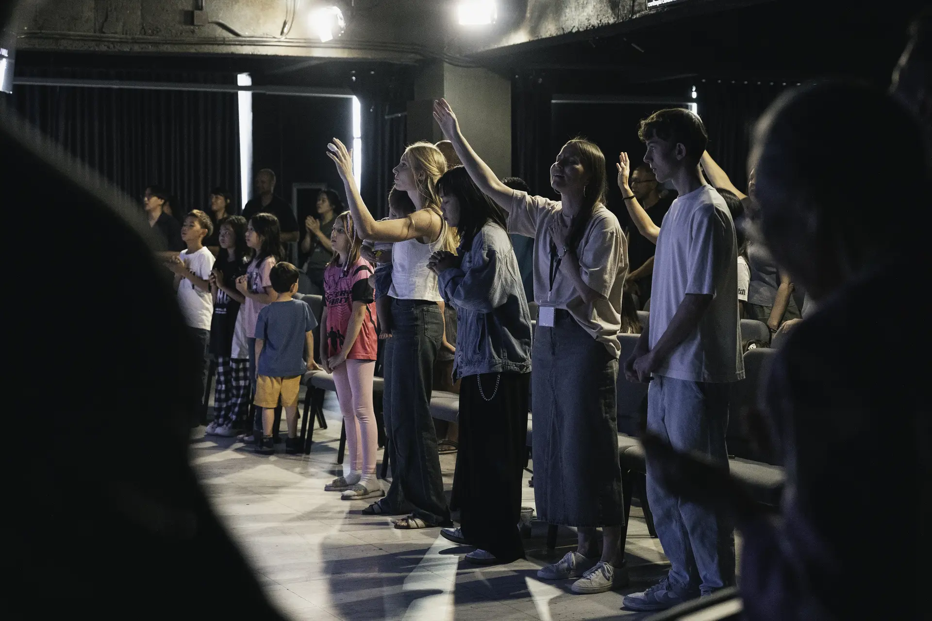 A congregation stands together during worship
